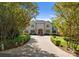 Elegant two-story home featuring manicured landscaping and a circular driveway with a fountain at 200 Highland Forest Dr, Charlotte, NC 28270