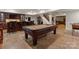 Spacious game room with a large pool table, tiled floor, and bar area for entertaining guests at 200 Highland Forest Dr, Charlotte, NC 28270