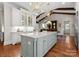 Spacious kitchen with a center island, custom cabinetry, and modern lighting fixtures at 200 Highland Forest Dr, Charlotte, NC 28270
