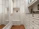 Organized mudroom featuring built-in storage cabinets and bench seating with hooks for coats and accessories at 200 Highland Forest Dr, Charlotte, NC 28270