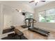 Bright workout room with mirrored wall, weight bench, ceiling fan, and a treadmill at 200 Highland Forest Dr, Charlotte, NC 28270