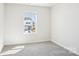 Comfortable bedroom with neutral walls, carpet, and a view of the neighborhood at 2060 Old Rivers Rd, Concord, NC 28027
