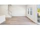 Open living area with modern flooring, neutral walls, large windows and staircase at 2060 Old Rivers Rd, Concord, NC 28027