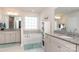 Bright bathroom featuring double vanities, soaking tub and lots of natural light at 2097 Saddlebred Dr, Iron Station, NC 28080