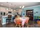 Bright dining area featuring hardwood floors, white cabinets, stainless appliances, and a charming hutch at 2097 Saddlebred Dr, Iron Station, NC 28080