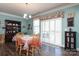Cozy dining area with wood table, white shutters, and a bright, airy feel at 2097 Saddlebred Dr, Iron Station, NC 28080