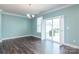 Dining room with hardwood floors, sliding door, and a modern chandelier at 2097 Saddlebred Dr, Iron Station, NC 28080