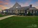 Charming home with covered porch and landscaped front yard, perfect for relaxing evenings at 2097 Saddlebred Dr, Iron Station, NC 28080