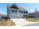 Stylish two-story home with a wide driveway and a well-maintained front lawn at 2097 Saddlebred Dr, Iron Station, NC 28080