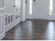 Inviting foyer featuring dark hardwood floors, white trim, and a glass paneled door at 2097 Saddlebred Dr, Iron Station, NC 28080