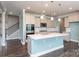 Modern kitchen with island, stainless appliances, and white countertops at 2097 Saddlebred Dr, Iron Station, NC 28080