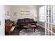 Inviting living room featuring a leather couch, hardwood floors, and natural light at 2097 Saddlebred Dr, Iron Station, NC 28080