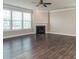 Spacious living room features hardwood floors, a fireplace, and large windows at 2097 Saddlebred Dr, Iron Station, NC 28080