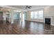 Open-concept living room with fireplace, hardwood floors, and lots of natural light at 2097 Saddlebred Dr, Iron Station, NC 28080