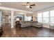 Open-concept living area with hardwood floors, a gray sectional sofa, and natural light at 2097 Saddlebred Dr, Iron Station, NC 28080