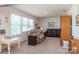 Comfortable living room featuring a plush recliner and a leather sofa near bright windows at 2097 Saddlebred Dr, Iron Station, NC 28080