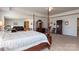Expansive primary bedroom boasts a four-poster bed and an adjacent seating area at 2097 Saddlebred Dr, Iron Station, NC 28080