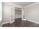 Bright office with dark hardwood floors, glass paneled doors, and white trim at 2097 Saddlebred Dr, Iron Station, NC 28080