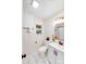 Bright bathroom with a single sink vanity, marble floors, and bronze fixtures at 2109 Tarlton Dr, Matthews, NC 28105