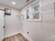 The laundry room contains a modern water heater, shelving, and a window at 2109 Tarlton Dr, Matthews, NC 28105
