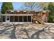 Backyard of a brick home with a deck, screened-in porch, and paved ground at 237 Palaside Ne Dr, Concord, NC 28025