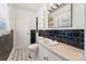 Bathroom featuring a white sink, black and white backsplash and patterned tile floor at 237 Palaside Ne Dr, Concord, NC 28025