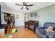 Charming Bedroom featuring wood floors, ceiling fan, an accent wall, crib, and comfortable chair at 237 Palaside Ne Dr, Concord, NC 28025