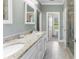 Bright bathroom featuring a double sink vanity, tile flooring, and a stand up shower at 244 Alexis Lucia Rd, Alexis, NC 28006