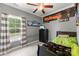 Comfortable bedroom with a window, ceiling fan, sports decor, and neutral-toned walls at 244 Alexis Lucia Rd, Alexis, NC 28006