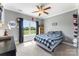 Comfortable bedroom with blue checkered bedding, a ceiling fan, a large window, and a dark dresser at 244 Alexis Lucia Rd, Alexis, NC 28006