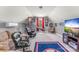 This bonus room includes basketball hoops, tv and furnishings at 244 Alexis Lucia Rd, Alexis, NC 28006
