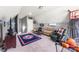 This bonus room is furnished with a sofa, chair, tv and basketball hoop at 244 Alexis Lucia Rd, Alexis, NC 28006