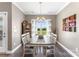 Formal dining room with a rustic wood table, tasteful decor, and large windows offering views of the surrounding landscape at 244 Alexis Lucia Rd, Alexis, NC 28006