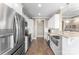 Modern kitchen featuring stainless steel appliances, white cabinets, granite countertops, and wood-look flooring at 244 Alexis Lucia Rd, Alexis, NC 28006
