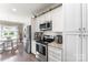 Modern kitchen featuring stainless steel appliances, white cabinets, granite countertops, and wood flooring at 244 Alexis Lucia Rd, Alexis, NC 28006