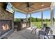 Covered outdoor living space with stone fireplace, built in grill, and outdoor seating at 244 Alexis Lucia Rd, Alexis, NC 28006