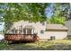 Backyard view showcasing a spacious wood deck, tan vinyl siding, and mature trees at 2512 Pimpernel Rd, Charlotte, NC 28213