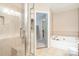Bathroom features a walk-in shower, a soaking tub, and neutral tiles at 2512 Pimpernel Rd, Charlotte, NC 28213