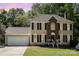 Traditional two-story home with black shutters, set against a backdrop of mature trees at 2512 Pimpernel Rd, Charlotte, NC 28213