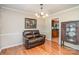 Cozy living room with hardwood floors, showcasing a leather sofa and dining room at 2512 Pimpernel Rd, Charlotte, NC 28213