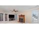 Inviting living room features a brick fireplace, ceiling fan, and sliding doors to the outdoors at 2512 Pimpernel Rd, Charlotte, NC 28213