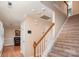 Carpeted staircase with wood railing leads to the upper level of the home at 2512 Pimpernel Rd, Charlotte, NC 28213