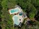 Aerial view of a community pool area featuring multiple pools, lounge chairs, and landscaped surroundings at 2906 Crescent Knoll Dr, Matthews, NC 28105