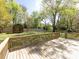 Fenced back yard with a wooden shed and a manicured lawn viewed from the deck at 2906 Crescent Knoll Dr, Matthews, NC 28105