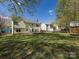 Sprawling back yard with mature trees offering ample shade, and a charming storage shed at 2906 Crescent Knoll Dr, Matthews, NC 28105