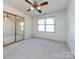 Bright bedroom featuring a ceiling fan, a large window and mirrored closet doors at 2906 Crescent Knoll Dr, Matthews, NC 28105