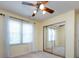 Bedroom featuring a ceiling fan, bright natural light, and mirrored closet doors at 2906 Crescent Knoll Dr, Matthews, NC 28105