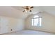 Attic bedroom with a ceiling fan, neutral carpet, and a window with an arched top at 2906 Crescent Knoll Dr, Matthews, NC 28105