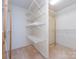 A walk in closet with built in shelving at 2906 Crescent Knoll Dr, Matthews, NC 28105