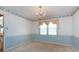 Cozy dining room featuring a chandelier, a window with valances, and striped wallpaper at 2906 Crescent Knoll Dr, Matthews, NC 28105